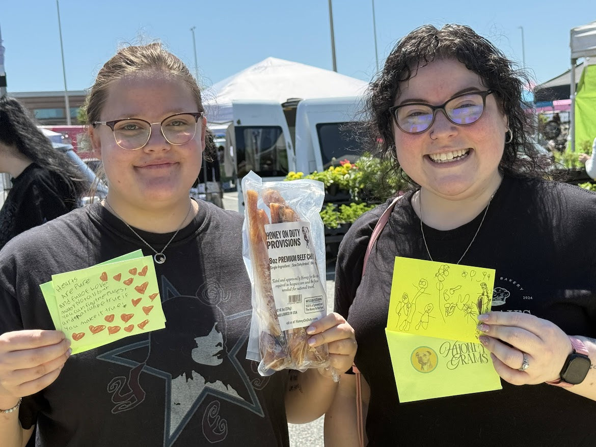 Happy customers showing off Honey On Duty Provisions beef chews at a local market