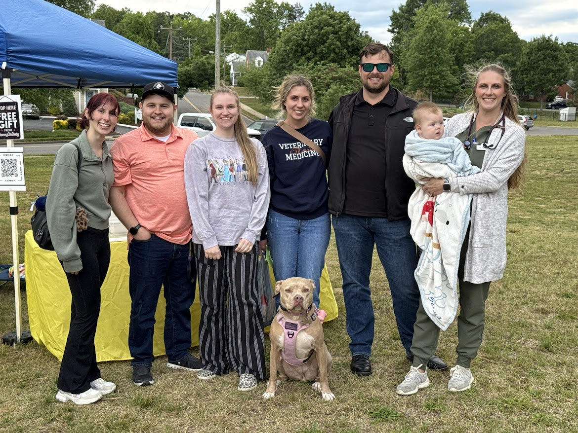 Honey the service dog with Stefan and supporters at an outdoor community event