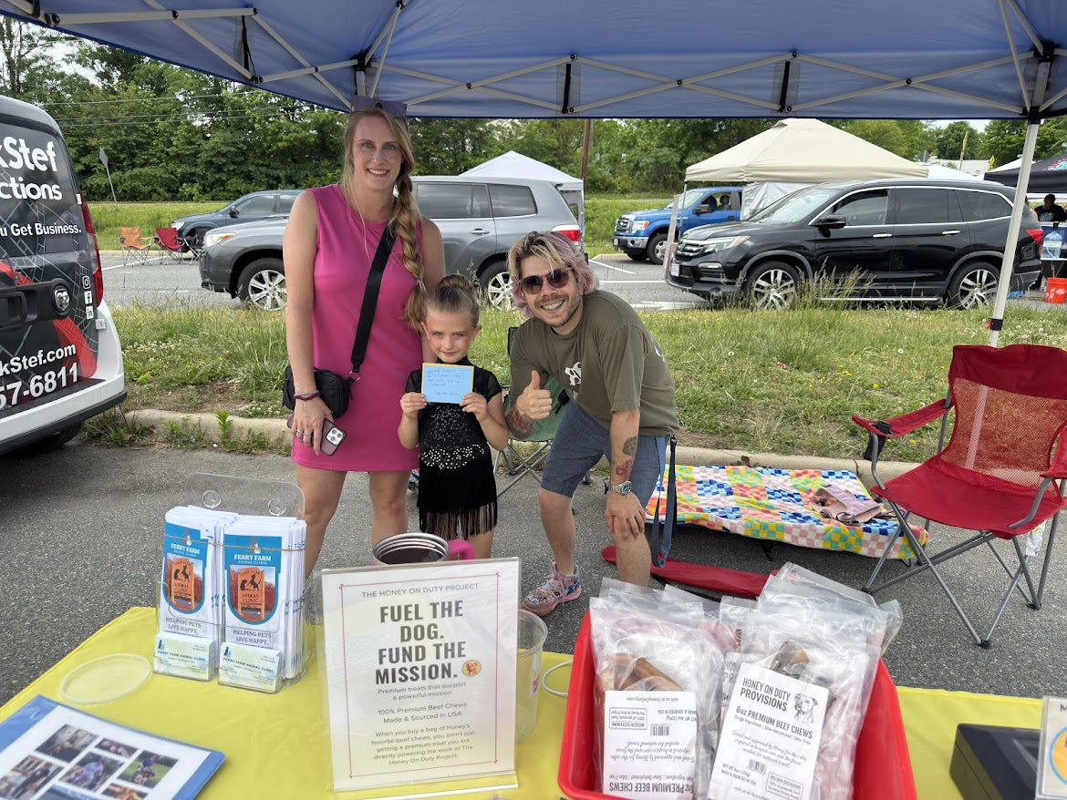 Family visiting the Honey On Duty Provisions booth at a local market event